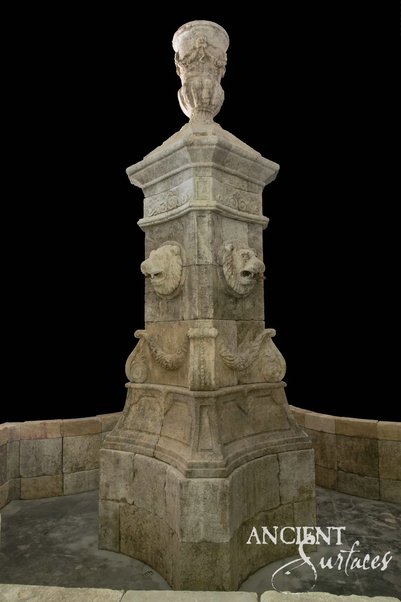 Monumental reclaimed limestone pool fountain pier with carved lion head mascaron spouts, a foliate scroll frieze and a carved urn finial