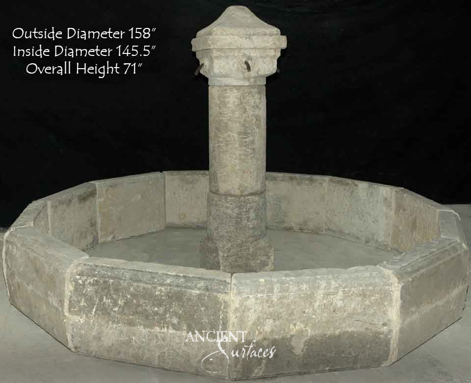 Very large twelve sided reclaimed limestone pool fountain with a plain cylindrical column and four short iron spouts in a faceted head